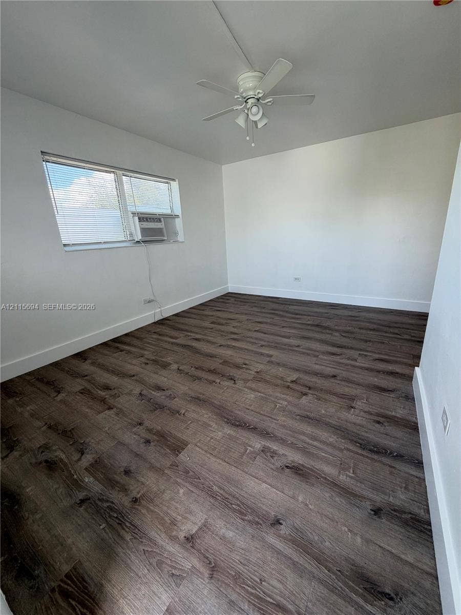 619 SW 7th Avenue, #7, Miami, Miami, FL 33130 Interior room featuring wood-finish flooring, white walls, and a ceiling-mounted fan with integrated lighting