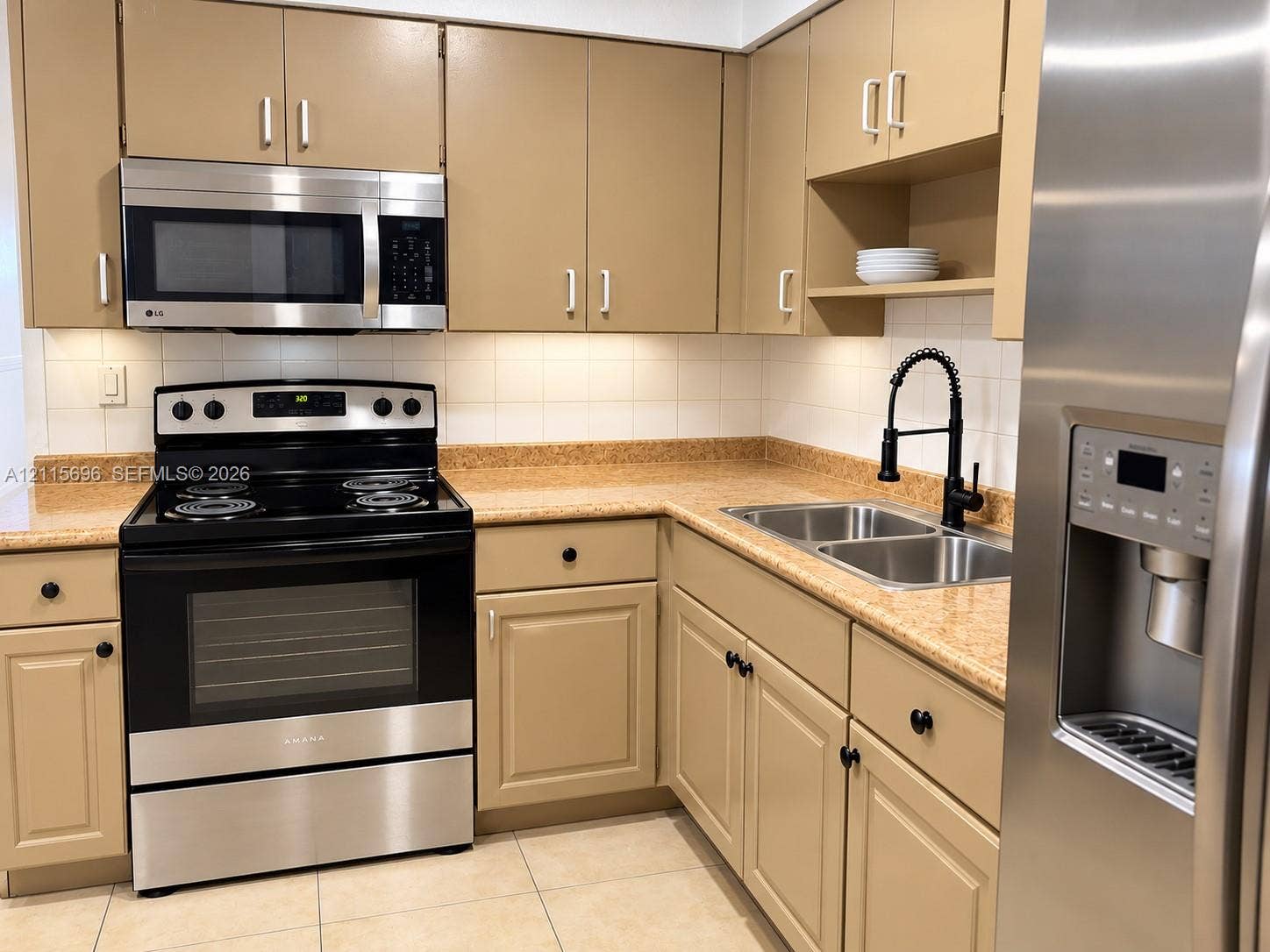 1101 NW 55th Avenue, #B, Lauderhill, Lauderhill, FL 33313 Kitchen featuring stainless steel appliances, neutral cabinetry, stone-finish countertops, ceramic tile backsplash, and a high-arch pull-down faucet
