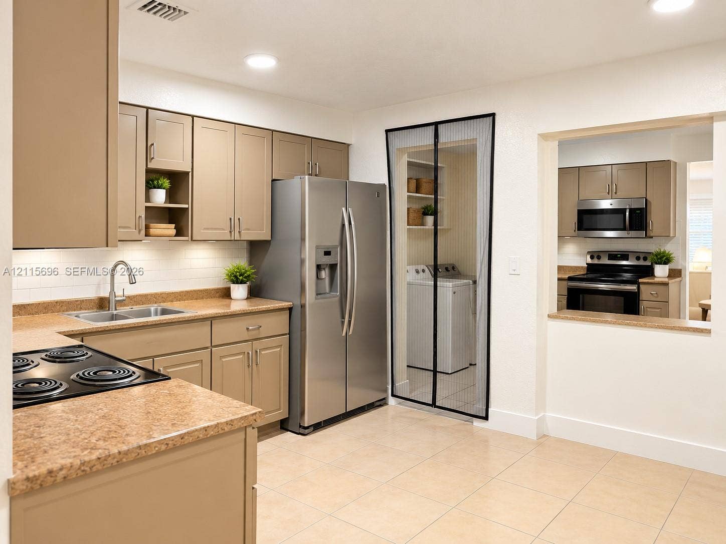 1101 NW 55th Avenue, #B, Lauderhill, Lauderhill, FL 33313 Kitchen featuring flat-panel cabinetry, stone-texture countertops, white subway tile backsplash, stainless steel refrigerator, and recessed lighting