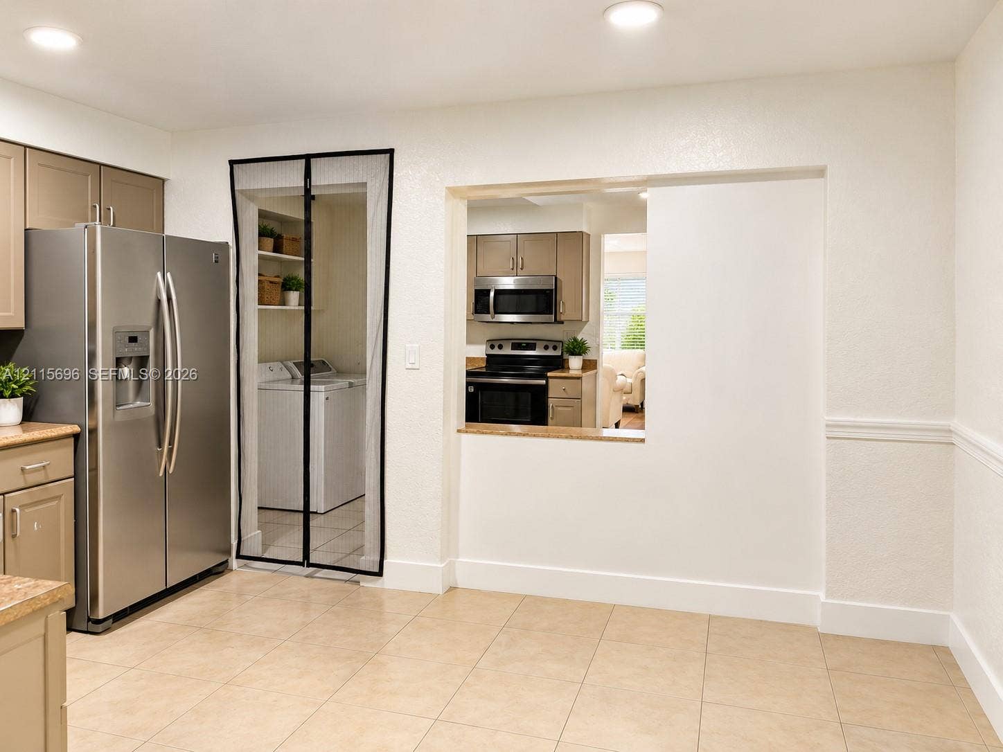 1101 NW 55th Avenue, #B, Lauderhill, Lauderhill, FL 33313 Kitchen featuring tan cabinetry, stainless steel side-by-side refrigerator, recessed lighting, and tile flooring, with a pass-through opening to a cooking area