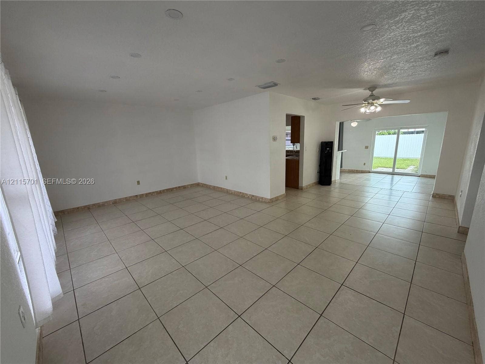 8641 NW 25th Court, #864, Sunrise, Sunrise, FL 33322 Neutral-toned tile flooring, recessed ceiling lighting, ceiling fan, and sliding glass door
