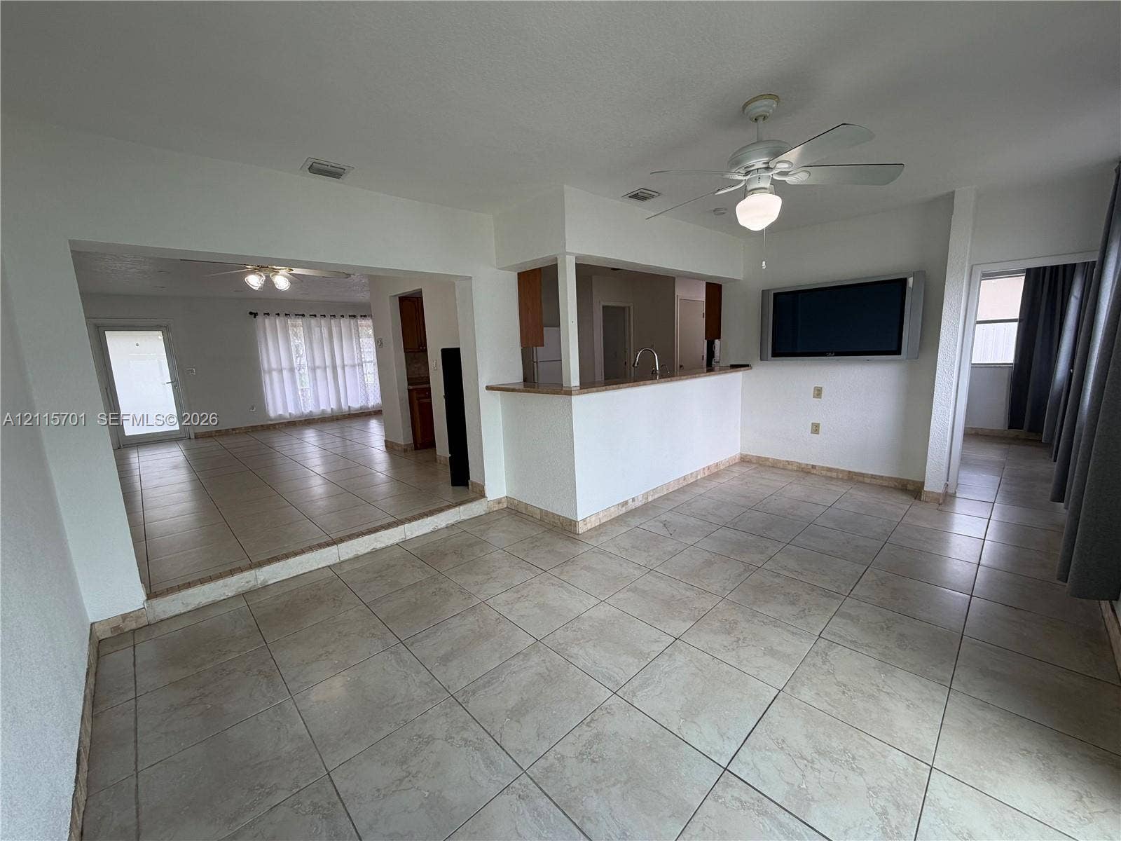 8641 NW 25th Court, #864, Sunrise, Sunrise, FL 33322 Neutral-toned ceramic tile flooring, kitchen pass-through counter, and ceiling-mounted lighting fixtures
