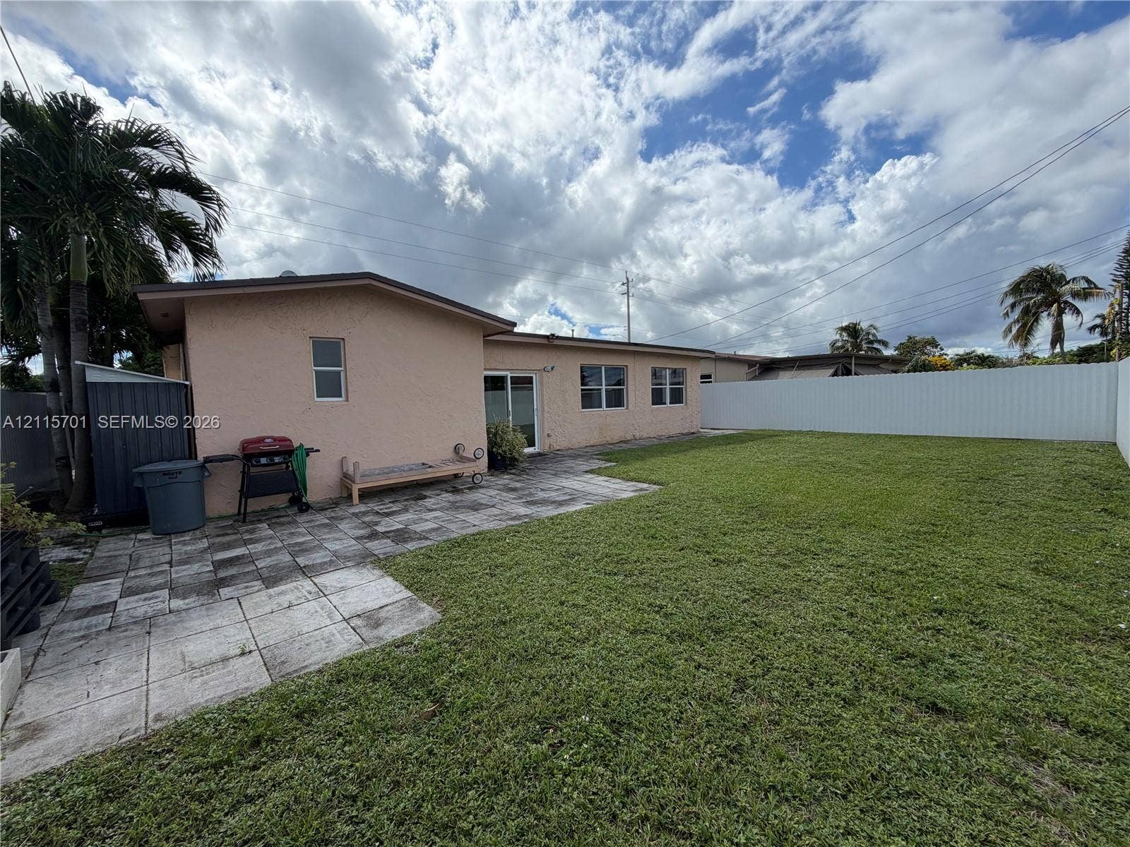 8641 NW 25th Court, #864, Sunrise, Sunrise, FL 33322 Stucco exterior with a rear paver patio, expansive grass lawn, and full-perimeter privacy fencing