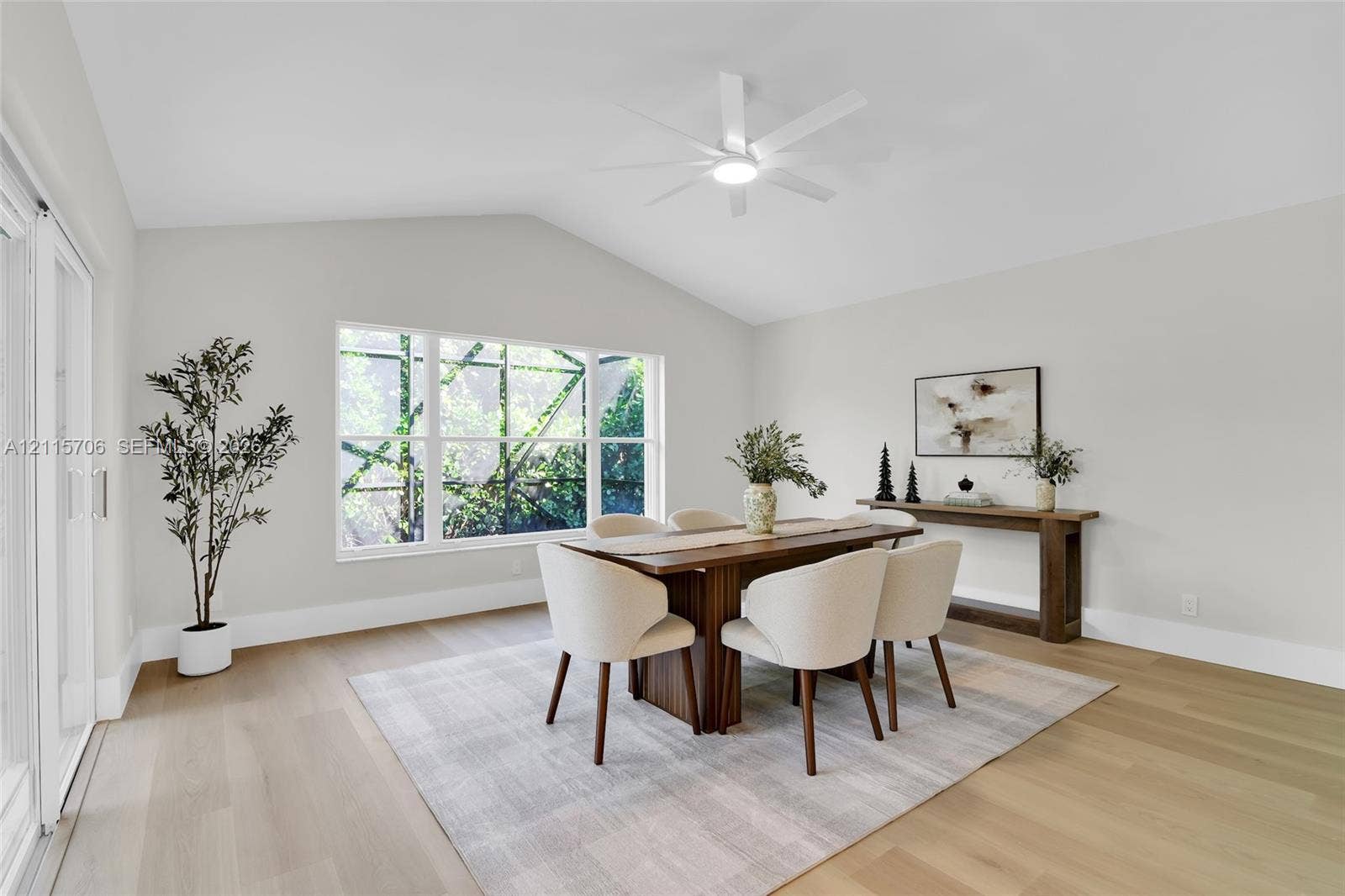 5184 Deerhurst Crescent Circle, Boca Raton, FL 33486 Vaulted ceilings, wood-finish flooring, multi-pane window, and white ceiling fan with integrated lighting