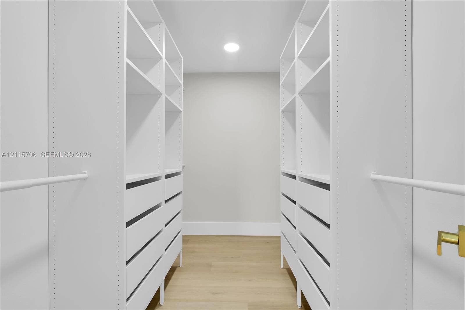 5184 Deerhurst Crescent Circle, Boca Raton, FL 33486 Built-in custom cabinetry featuring white shelving, multiple integrated storage drawers, and white hanging rods, complemented by wood-finish flooring and recessed ceiling lighting