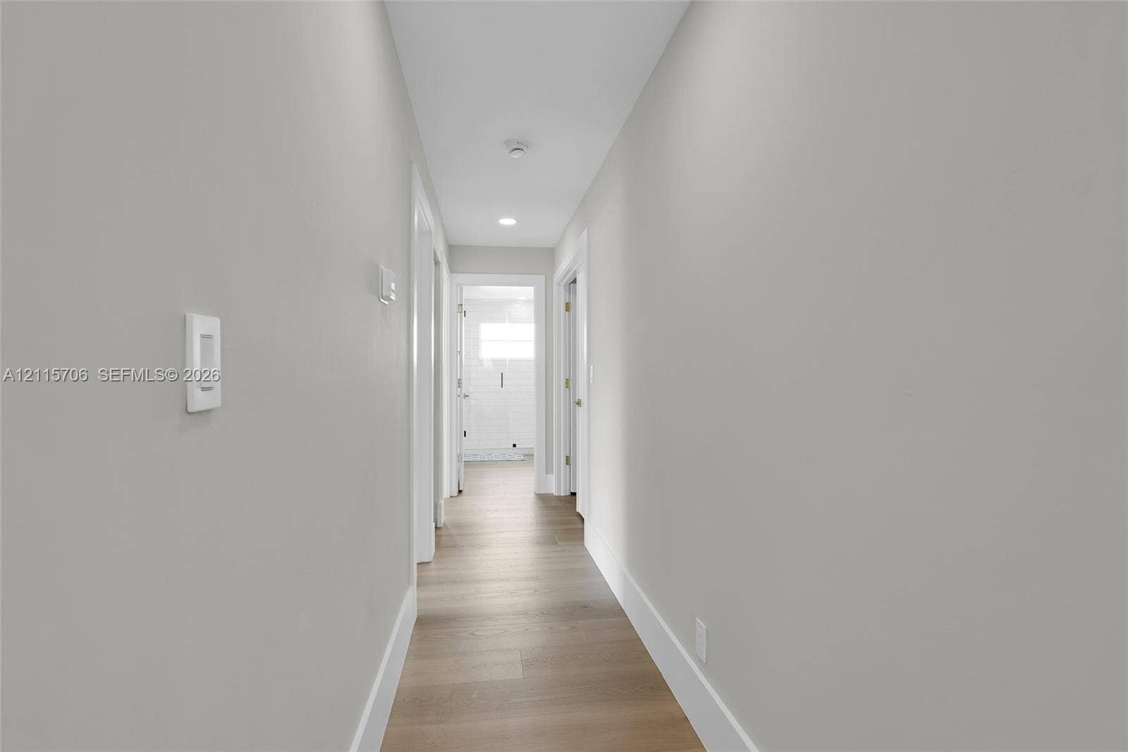 5184 Deerhurst Crescent Circle, Boca Raton, FL 33486 Hallway featuring neutral wall tones, wood-finish flooring, and recessed ceiling lighting