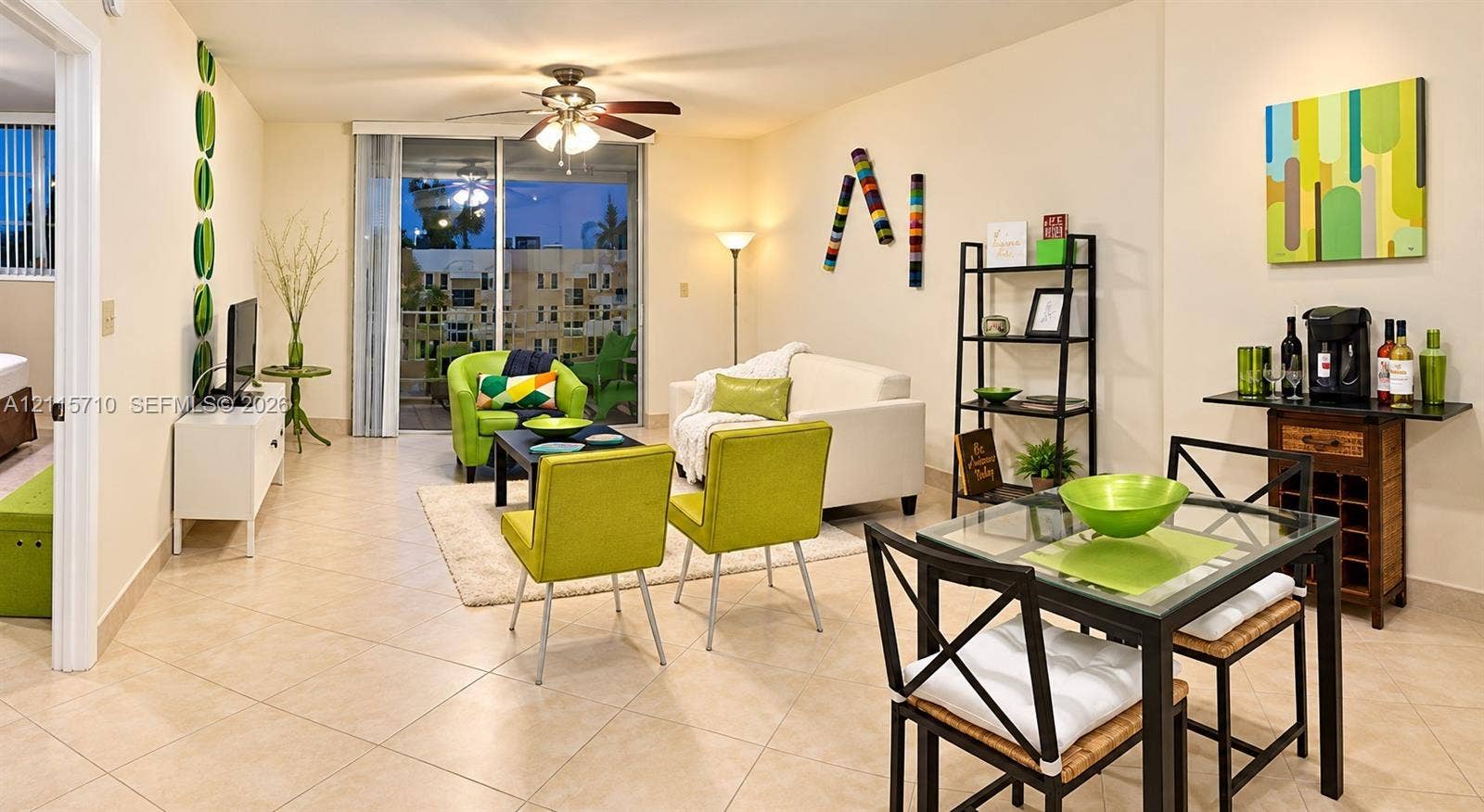 406 NW 68th Avenue, #115, Plantation, Plantation, FL 33317 Living area featuring large-format ceramic tile flooring, a ceiling fan with integrated lighting, and a sliding glass door providing external access