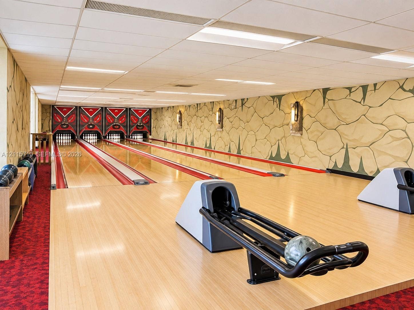 406 NW 68th Avenue, #115, Plantation, Plantation, FL 33317 Private multi-lane bowling alley featuring polished hardwood lanes, ball returns, pinsetters, and decorative wall murals