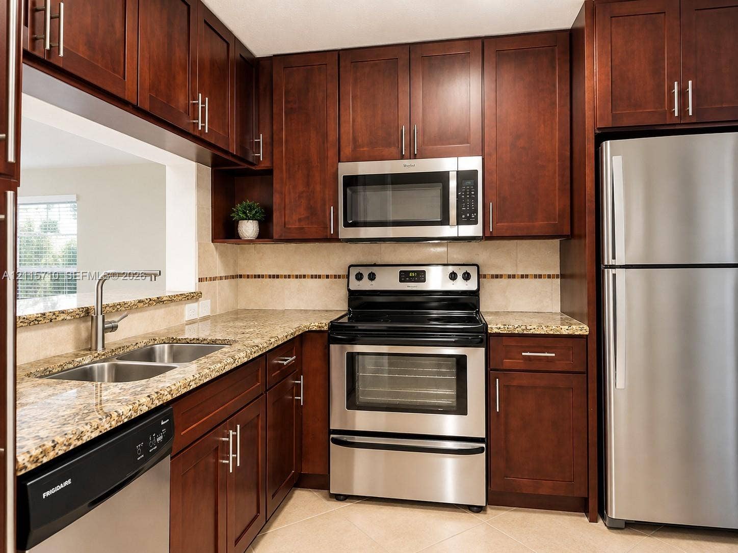 406 NW 68th Avenue, #115, Plantation, Plantation, FL 33317 Kitchen featuring dark wood cabinetry, stone-finish countertops, stainless steel appliances, and a double-basin under-mount sink