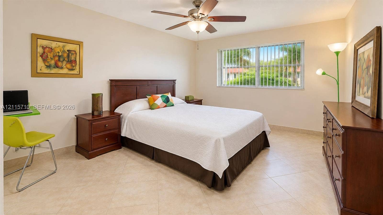 406 NW 68th Avenue, #115, Plantation, Plantation, FL 33317 Spacious room featuring neutral tile flooring, a horizontal sliding window with integrated security bars, and a multi-blade ceiling fan with an integrated light fixture