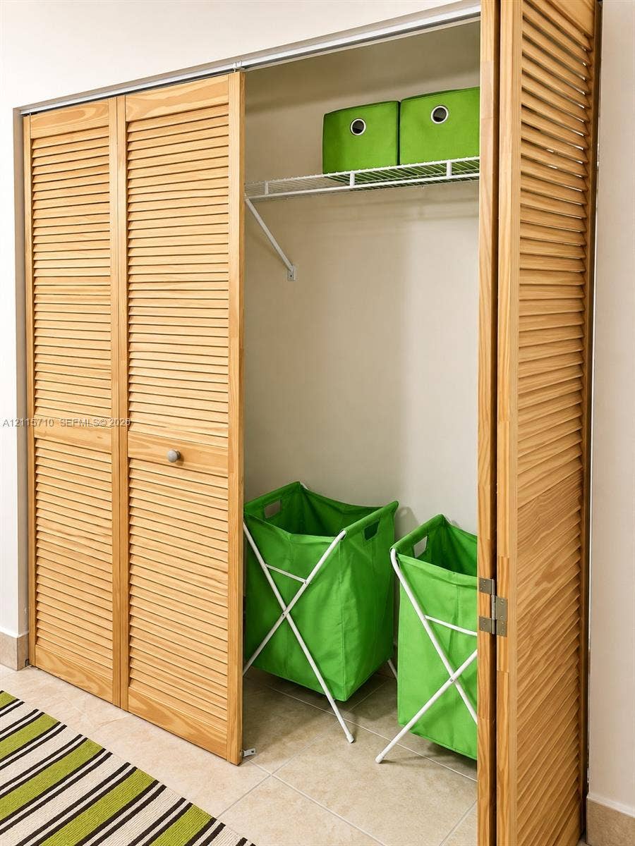 406 NW 68th Avenue, #115, Plantation, Plantation, FL 33317 Closet featuring light-finish wood bi-fold louvered doors and wire shelving