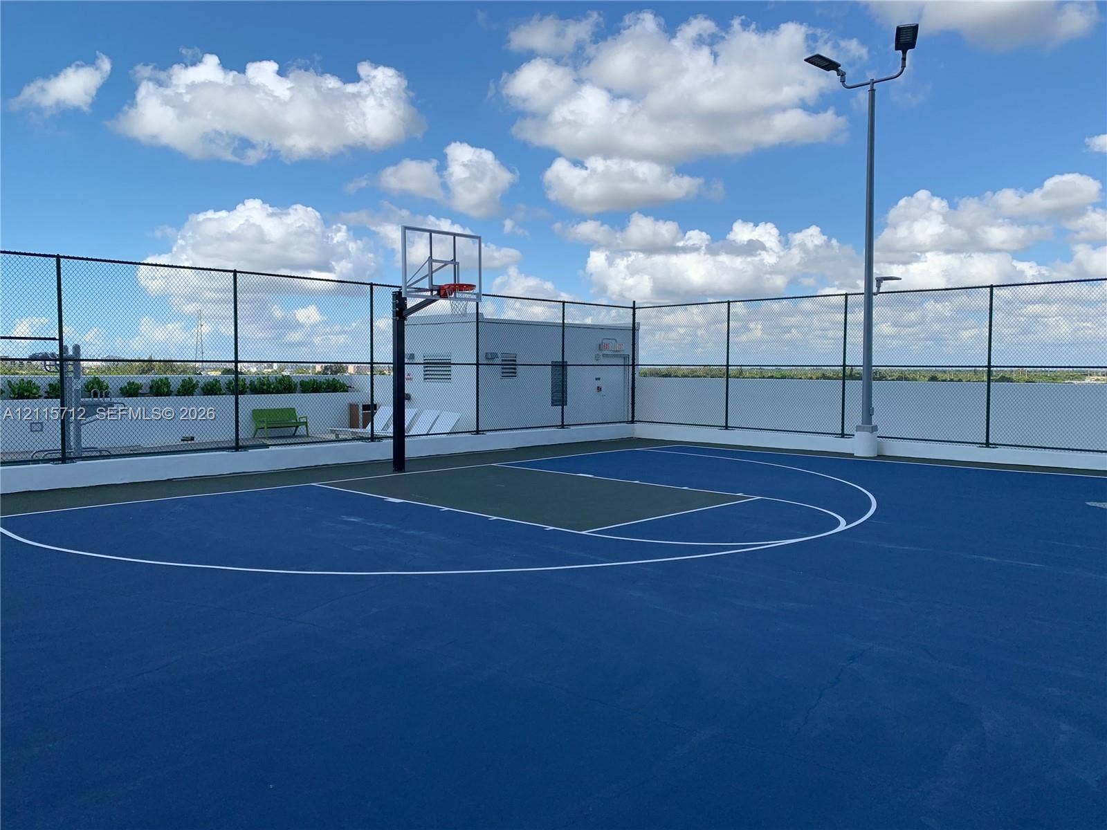 16385 Biscayne Boulevard, #1906, North Miami Beach, North Miami Beach, FL 33160 Rooftop basketball court featuring a high-performance surface, integrated lighting system, and full-perimeter chain-link fencing