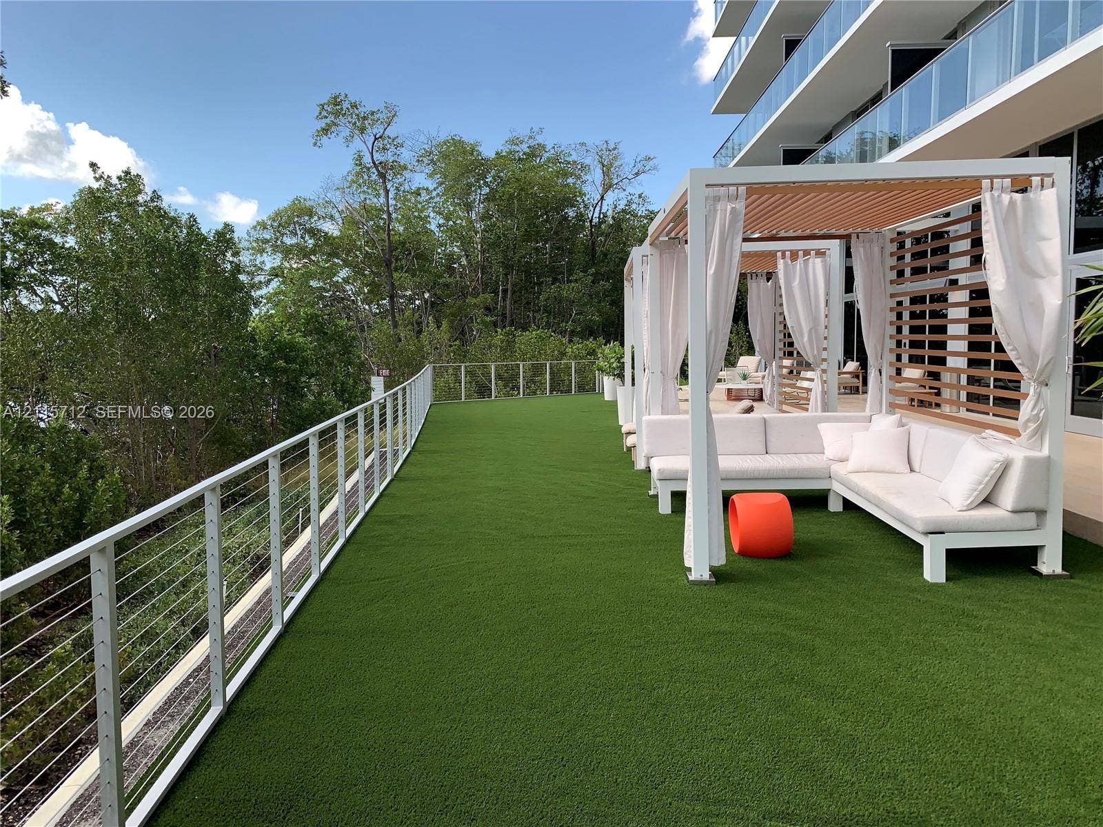 16385 Biscayne Boulevard, #1906, North Miami Beach, North Miami Beach, FL 33160 Spacious terrace featuring synthetic turf, metal cable railing, and structured wooden pergolas