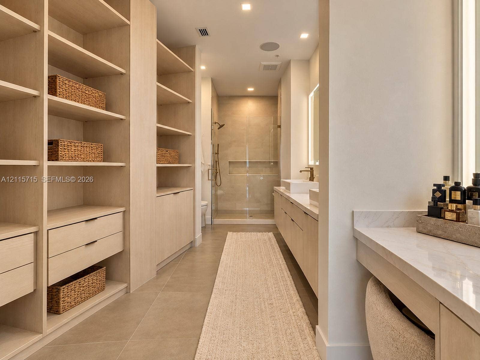 2001 Meridian Avenue, #514, Miami Beach, Miami Beach, FL 33139 Custom built-in wood cabinetry, expansive walk-in storage, dual-sink vanity with stone countertop, frameless glass shower enclosure, and recessed lighting