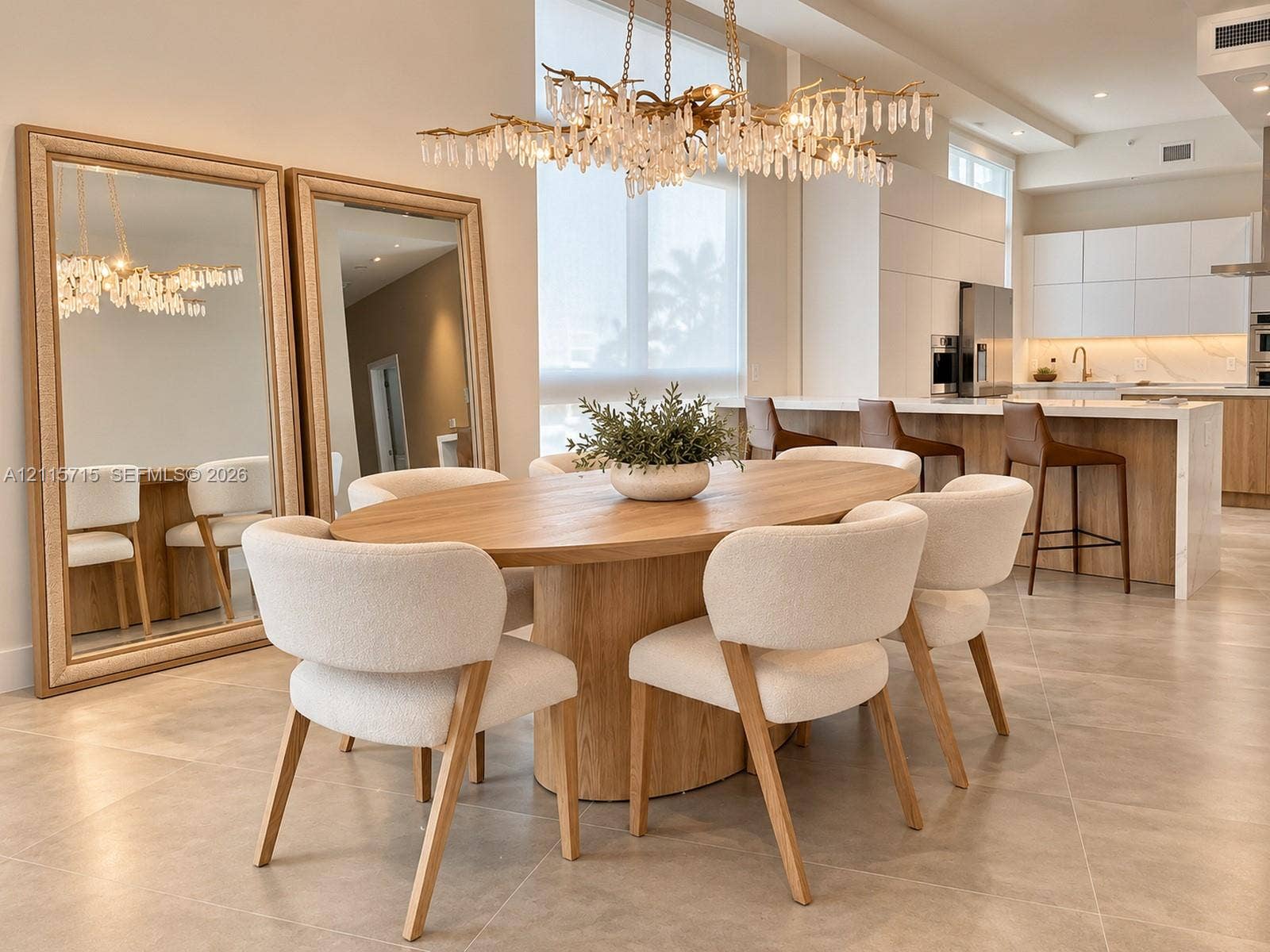 2001 Meridian Avenue, #514, Miami Beach, Miami Beach, FL 33139 Open-concept interior featuring large-format tile flooring, a multi-tiered crystal statement chandelier, and a kitchen equipped with handleless flat-panel cabinetry and a waterfall-edge island