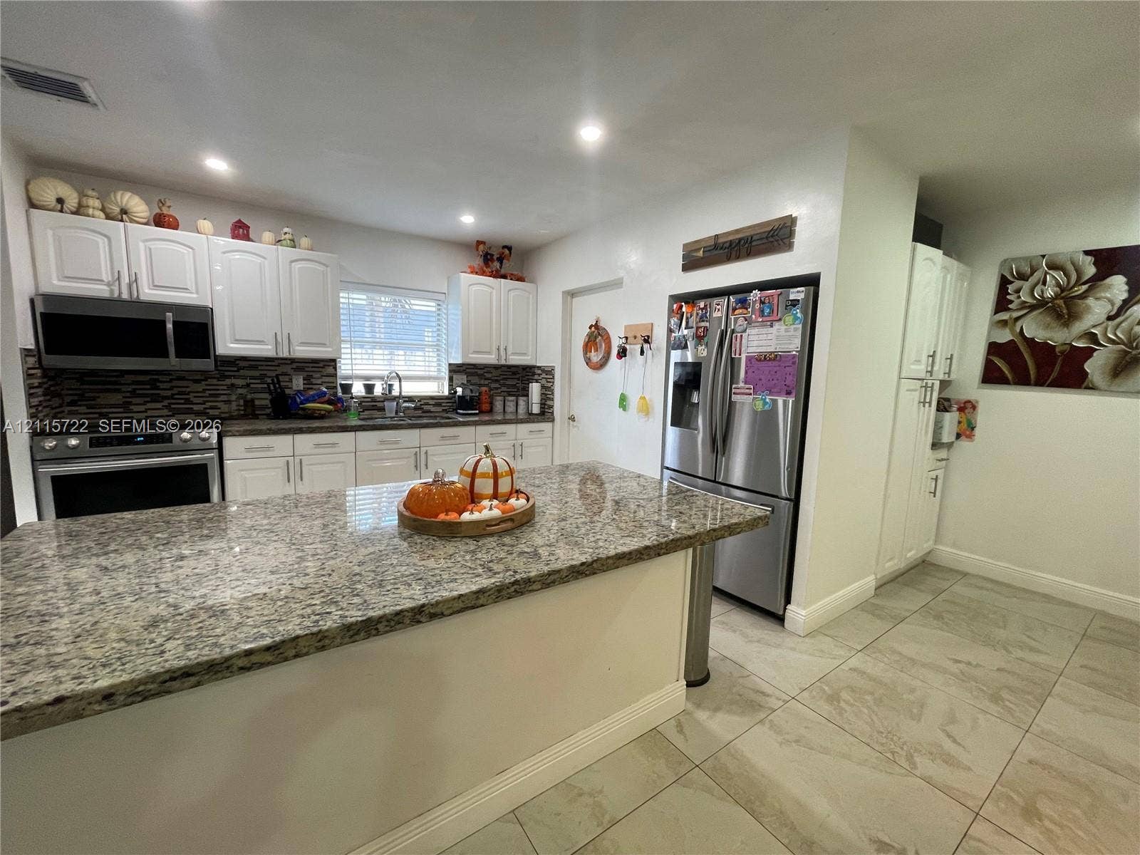 9852 SW 196th Street, Cutler Bay, FL 33157 Kitchen featuring white cabinetry, stone-surface countertops, tile flooring, recessed lighting, and stainless steel appliances