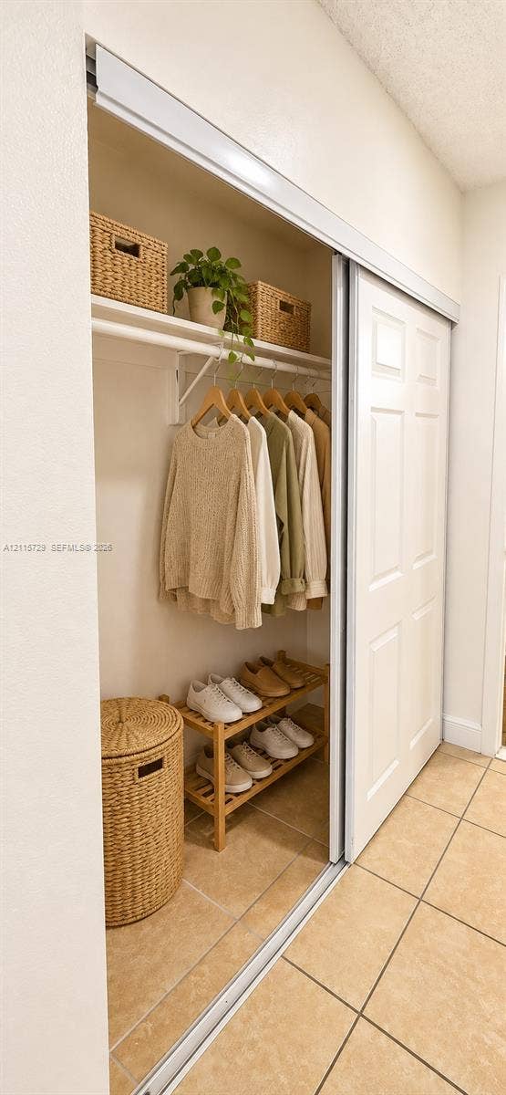 11110 SW 196th Street, #212, Cutler Bay, Cutler Bay, FL 33157 Closet featuring sliding multi-panel doors, upper shelving, and a horizontal hanging rod