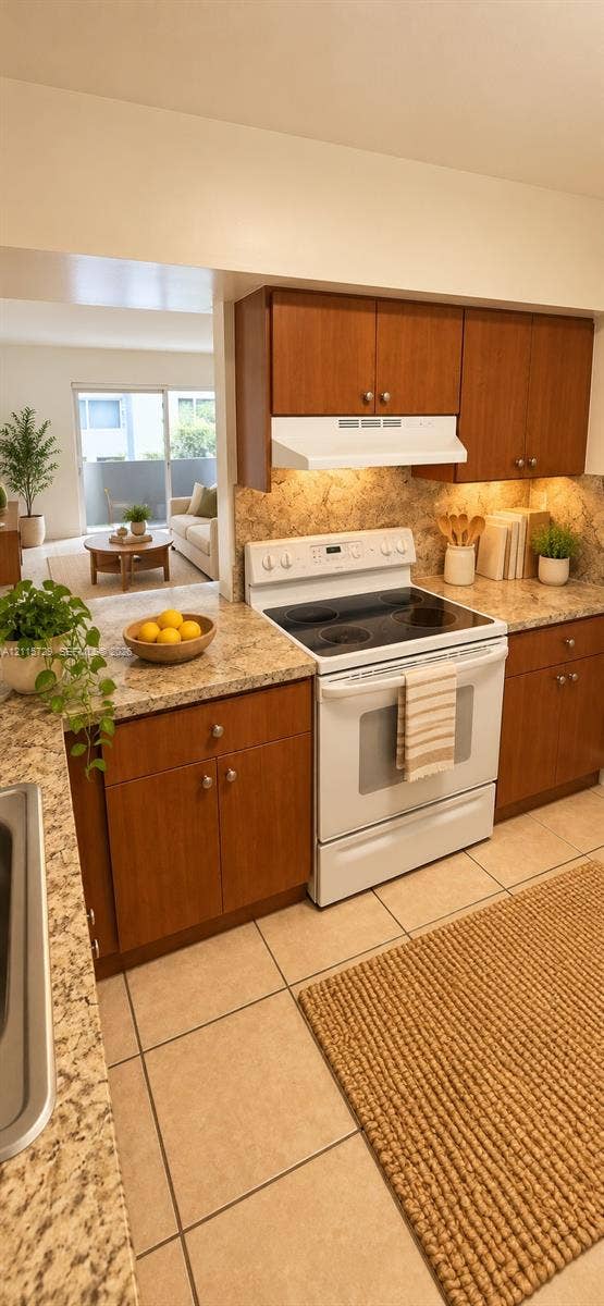 11110 SW 196th Street, #212, Cutler Bay, Cutler Bay, FL 33157 Kitchen featuring wood cabinetry, solid surface countertops, a white electric range, and ceramic tile flooring