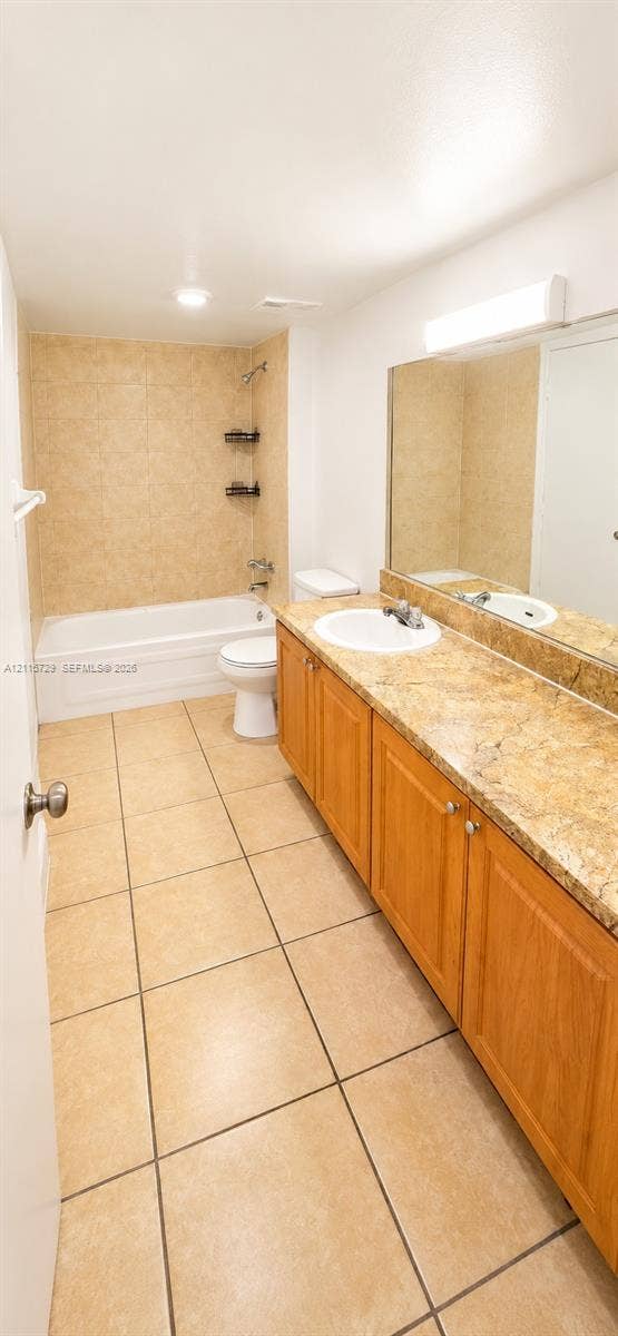 11110 SW 196th Street, #212, Cutler Bay, Cutler Bay, FL 33157 Bathroom featuring a vanity with a stone-finish countertop, undermount sink, ceramic tile flooring, and a shower-tub combination with tiled walls