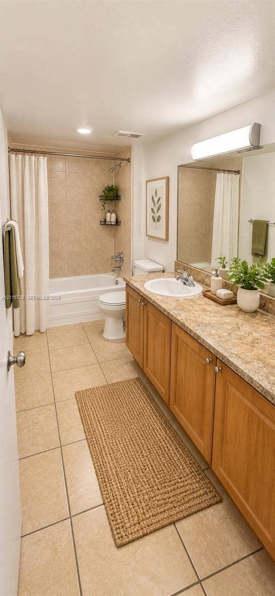 11110 SW 196th Street, #212, Cutler Bay, Cutler Bay, FL 33157 Bathroom featuring a wood-finish vanity with a stone-composite countertop, an integrated oval sink, a full-width vanity mirror, and ceramic tile flooring