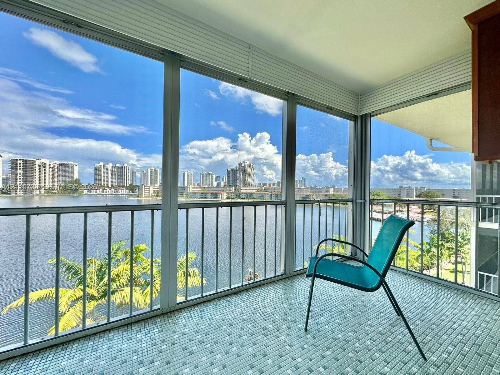 2861 Leonard Drive, #F605, Aventura, FL 33160 Enclosed balcony featuring floor-to-ceiling glass paneling, metal railing, and mosaic tile flooring