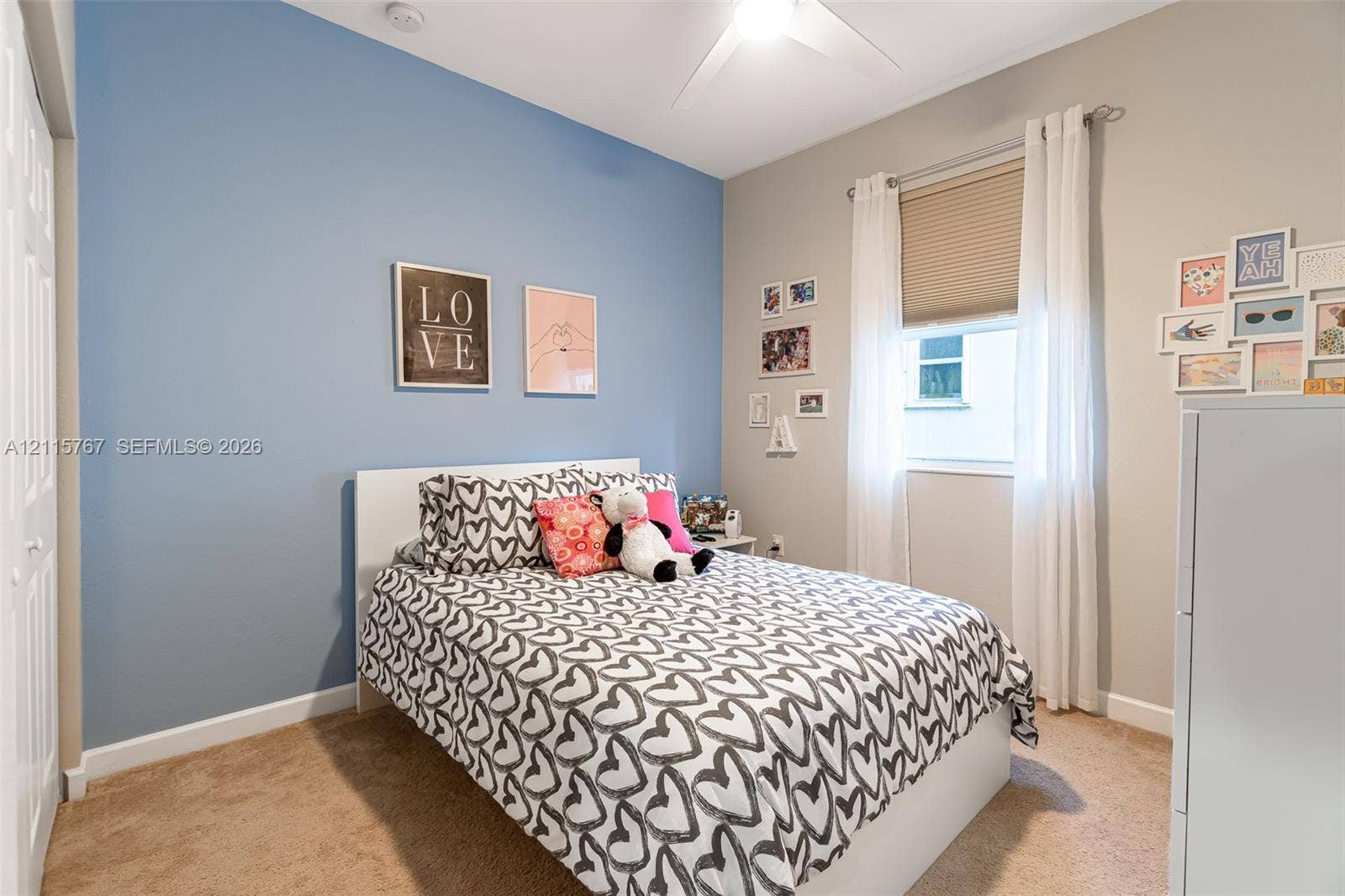 17046 SW 94th Lane, Miami, Miami, FL 33196 Neutral-toned walls with a blue accent wall, ceiling fan, and carpeting