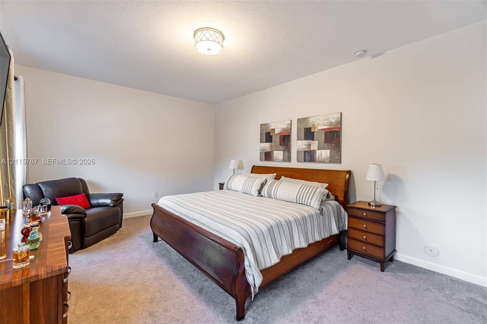 17046 SW 94th Lane, Miami, Miami, FL 33196 Neutral wall paint, plush carpeting, and a polished drum-style ceiling light fixture