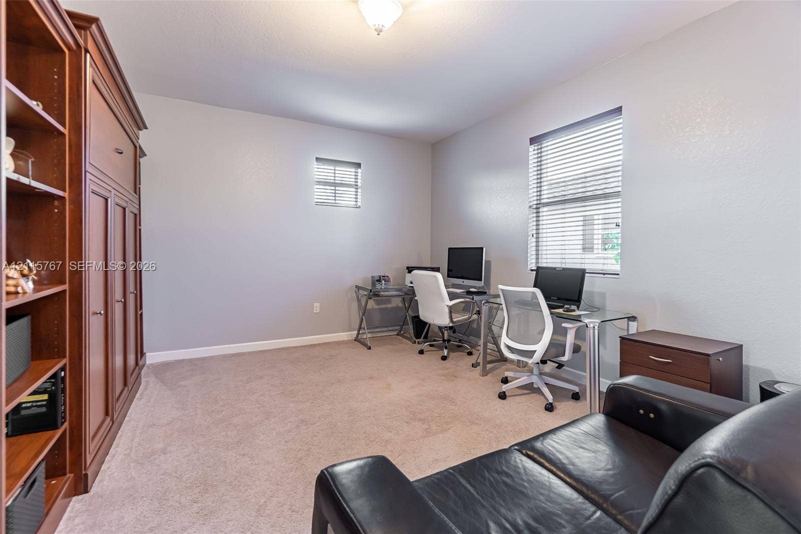 17046 SW 94th Lane, Miami, Miami, FL 33196 Built-in wood cabinetry with open shelving, neutral carpeting, dual window configurations with horizontal blinds, and a central ceiling light fixture