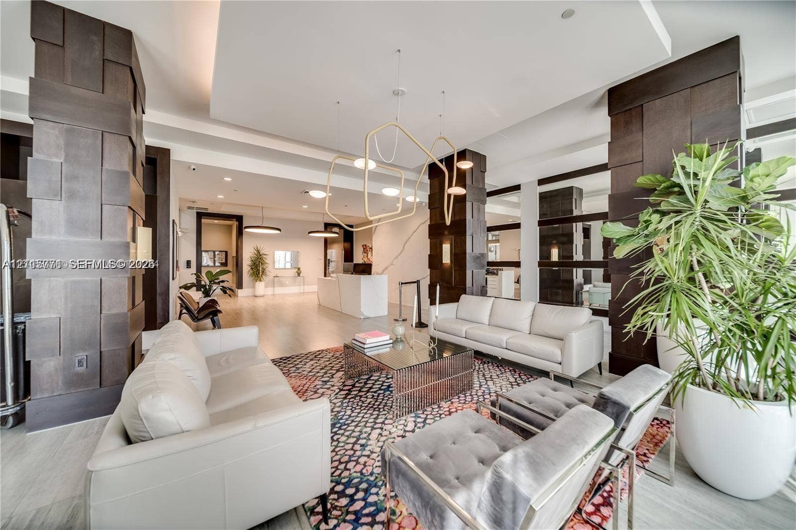 140 S Dixie Highway, #433, Hollywood, Hollywood, FL 33020 Expansive interior featuring high ceilings, architectural dark wood-paneled pillars, custom geometric pendant lighting, recessed lighting, and stone-finish flooring