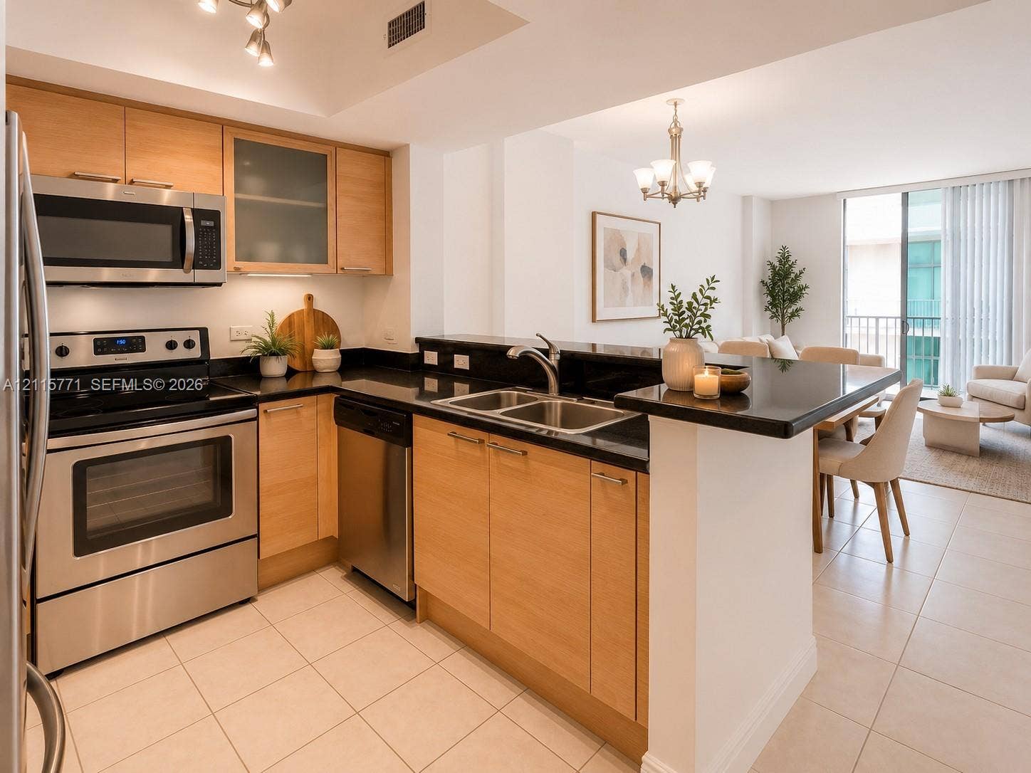 140 S Dixie Highway, #433, Hollywood, Hollywood, FL 33020 Kitchen featuring light wood-finish cabinetry, black countertops, stainless steel appliances, a dual-basin sink, and tile flooring