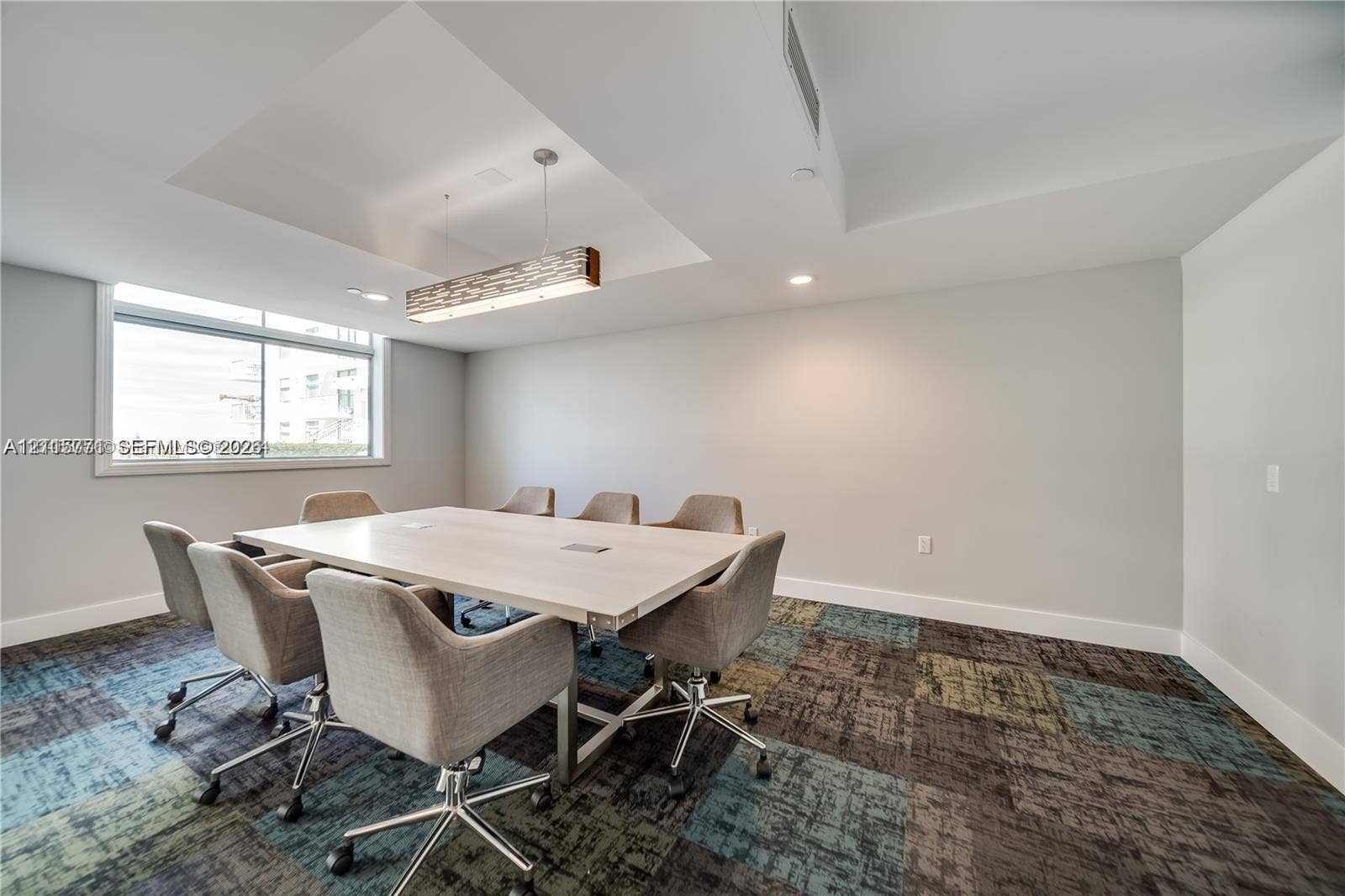 140 S Dixie Highway, #433, Hollywood, Hollywood, FL 33020 Recessed ceiling detail with a linear hanging light fixture, multi-tone patterned carpeting, and large horizontal window