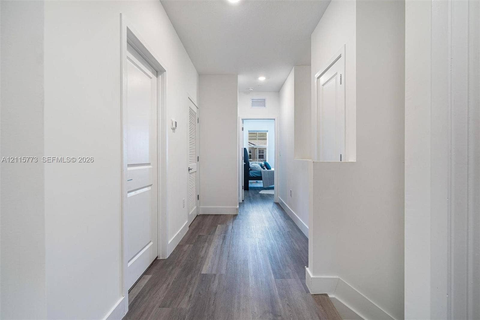 17033 SW 1st Street, #1, Pembroke Pines, Pembroke Pines, FL 33027 Hallway featuring wood-finish flooring, white paneled doors, recessed lighting, and crisp white wall finishes