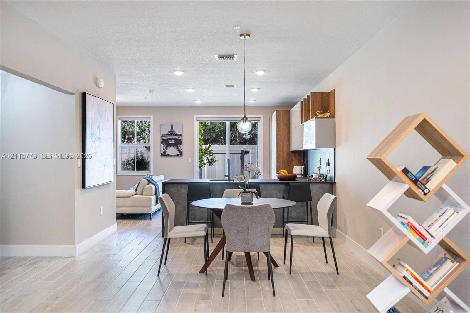 17033 SW 1st Street, #1, Pembroke Pines, Pembroke Pines, FL 33027 Open-concept kitchen featuring two-toned cabinetry, dark stone-finish countertops, recessed lighting, and wood-finish flooring