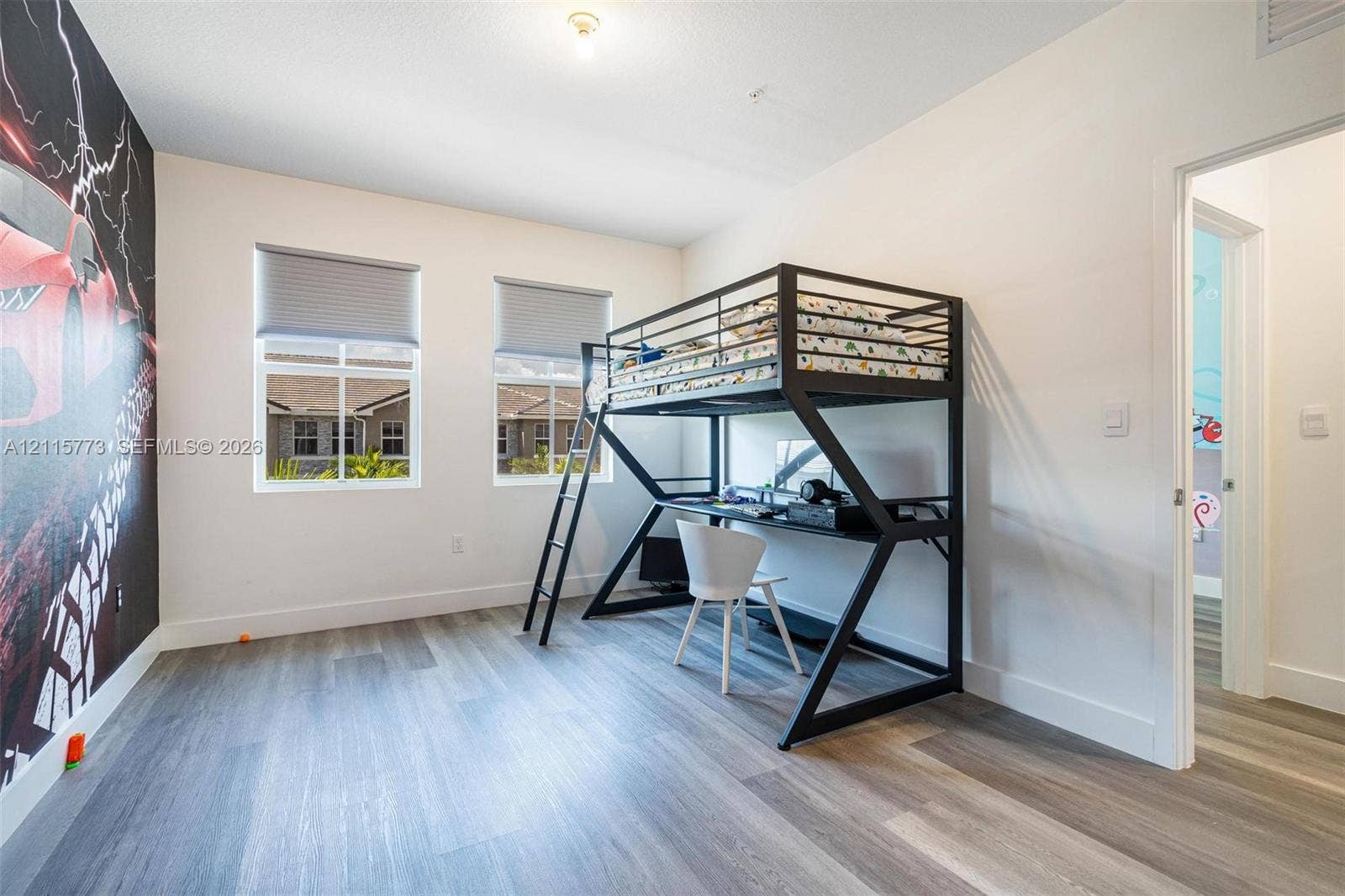 17033 SW 1st Street, #1, Pembroke Pines, Pembroke Pines, FL 33027 Spacious room featuring wood-finish flooring, dual windows with roller shades, and neutral wall paint