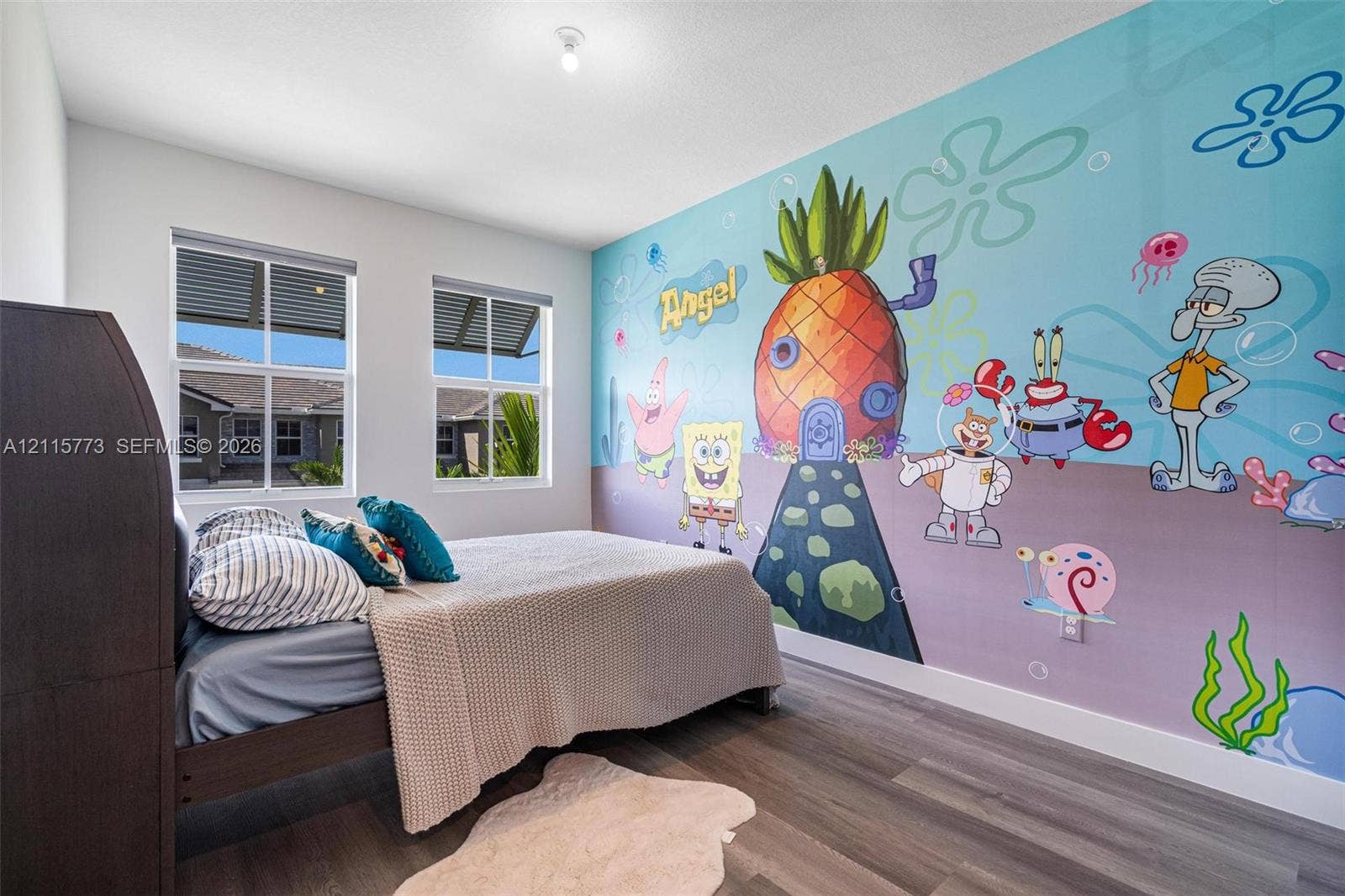 17033 SW 1st Street, #1, Pembroke Pines, Pembroke Pines, FL 33027 Bedroom featuring wood-finish flooring, dual windows with integrated blinds, and a full-wall custom mural