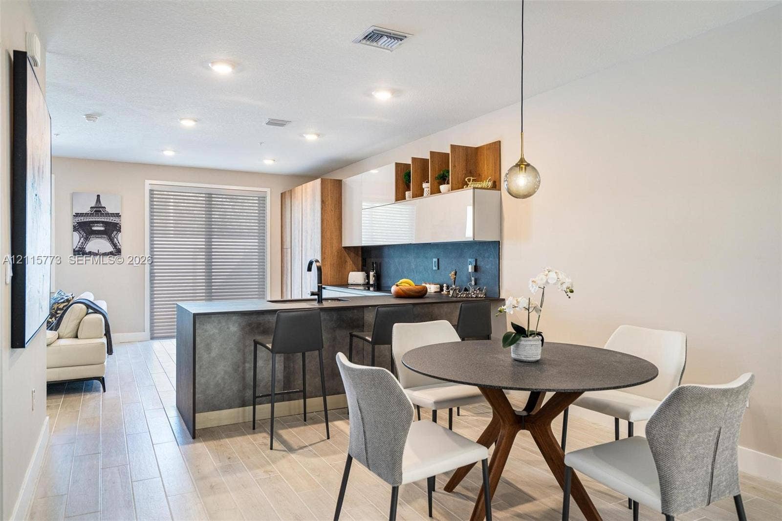 17033 SW 1st Street, #1, Pembroke Pines, Pembroke Pines, FL 33027 Kitchen featuring two-tone cabinetry with wood-finish shelving, stone-finish countertops, matte black plumbing fixtures, recessed ceiling lighting, and wood-finish flooring