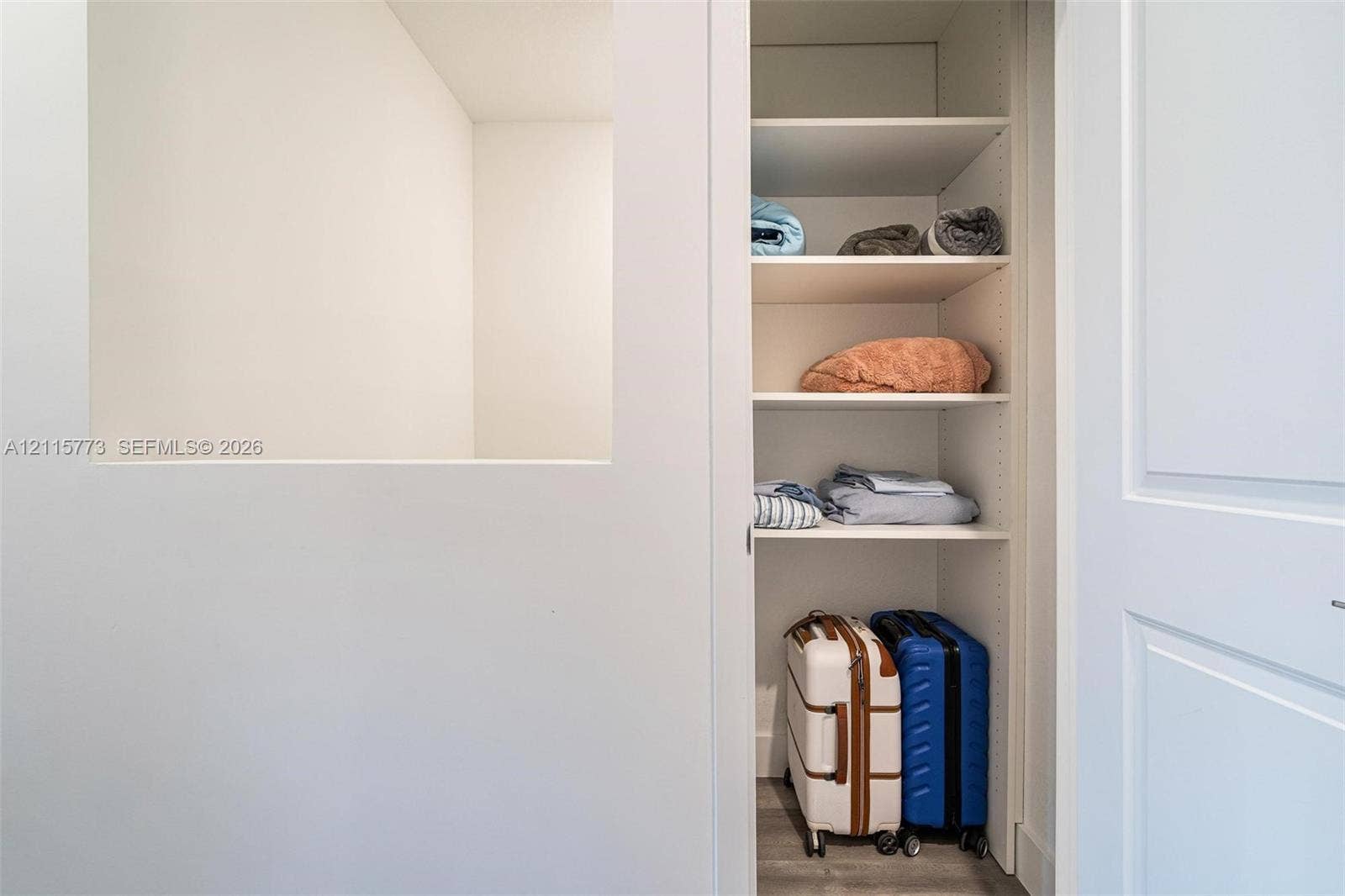 17033 SW 1st Street, #1, Pembroke Pines, Pembroke Pines, FL 33027 Built-in storage closet featuring white shelving and a paneled door
