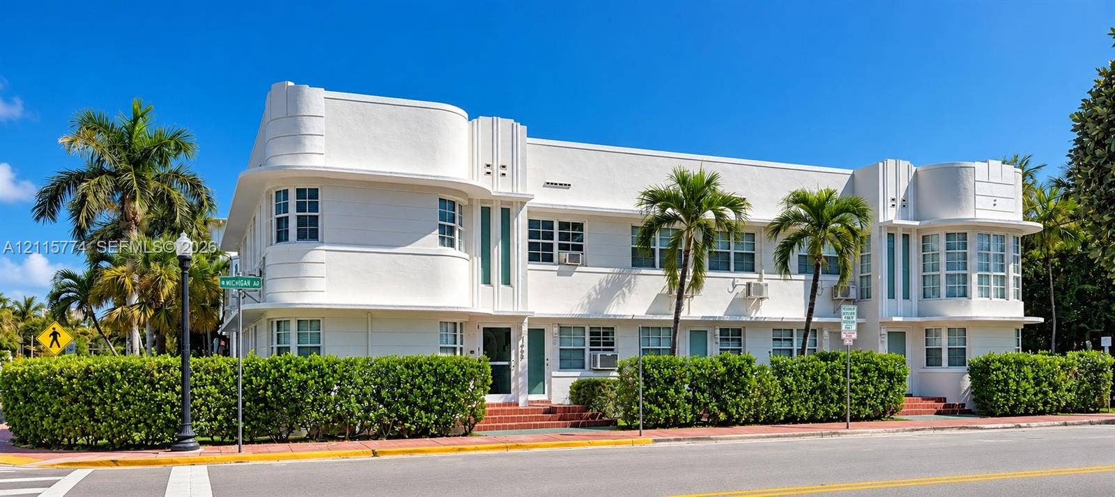 1455 Michigan Avenue, #19A, Miami Beach, Miami Beach, FL 33139 Art Deco exterior featuring rounded building corners, multi-pane casement windows, vertical decorative masonry detailing, and a smooth white stucco facade