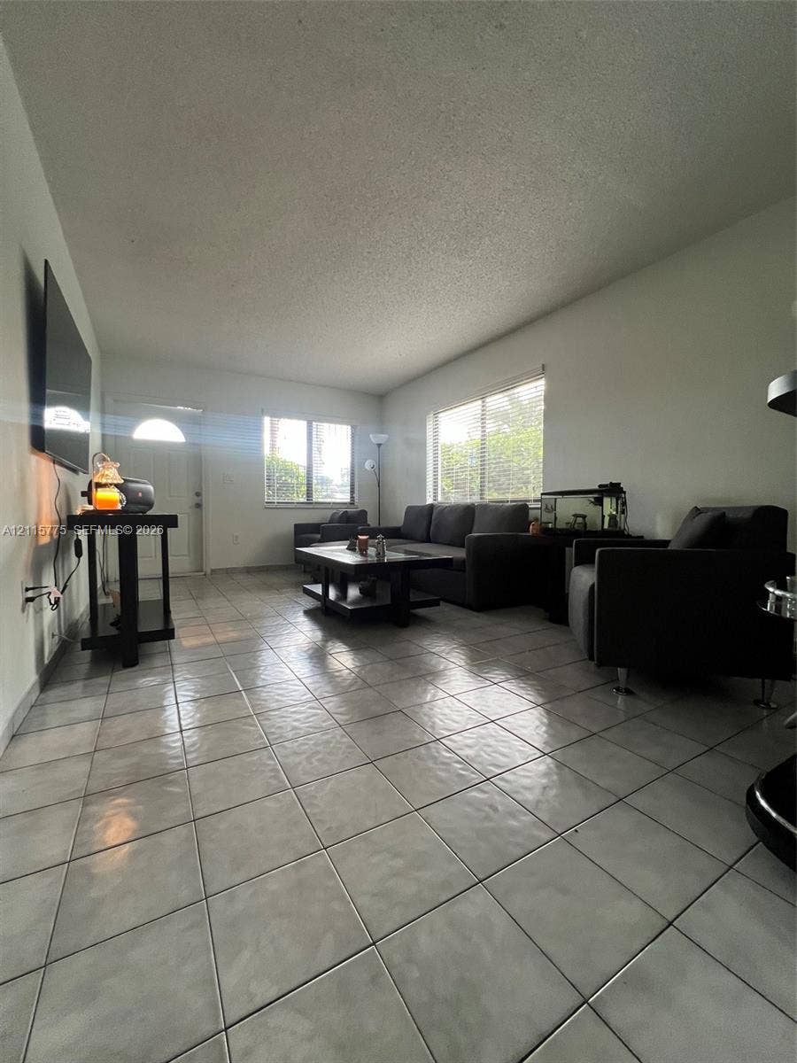 479 E 13th Street, #479, Hialeah, Hialeah, FL 33010 Neutral ceramic tile flooring, multiple windows providing natural light, and a dedicated entry door