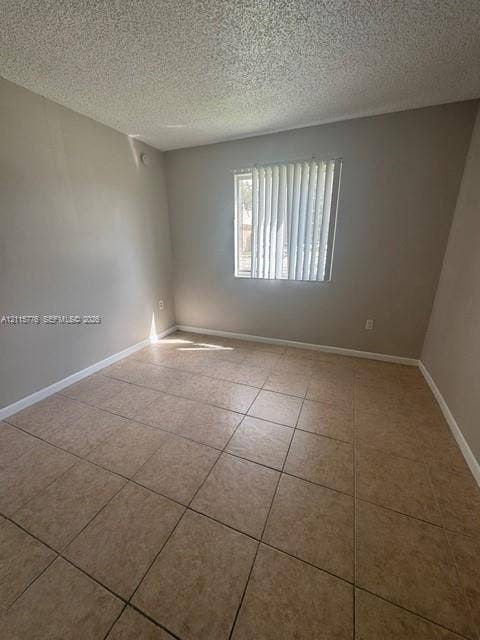 Room featuring neutral wall paint, square tile flooring, and vertical window blinds