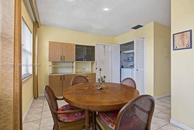 215 SE 3rd Avenue, #501B, Hallandale Beach, FL 33009 Neutral wall palette, light-toned tiled flooring, built-in cabinetry with integrated shelving, recessed lighting, and a louvered closet door