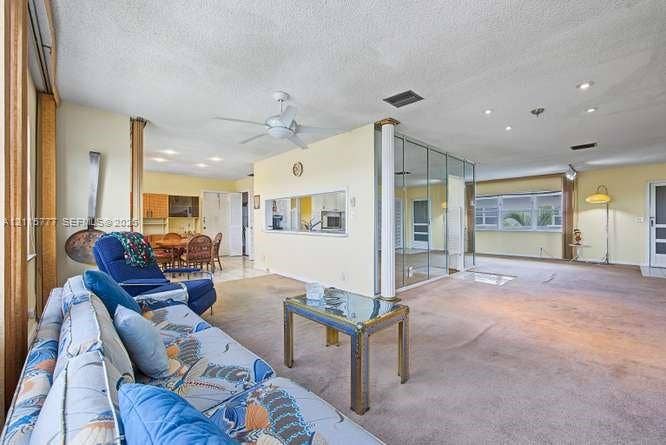215 SE 3rd Avenue, #501B, Hallandale Beach, FL 33009 Open-concept interior featuring recessed lighting, a ceiling fan, a structural support column, and mirrored accent wall panels