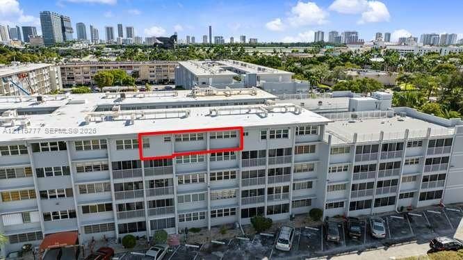 215 SE 3rd Avenue, #501B, Hallandale Beach, FL 33009 Multi-story residential building exterior featuring horizontal rows of windows, concrete structural framing, and private balcony spaces