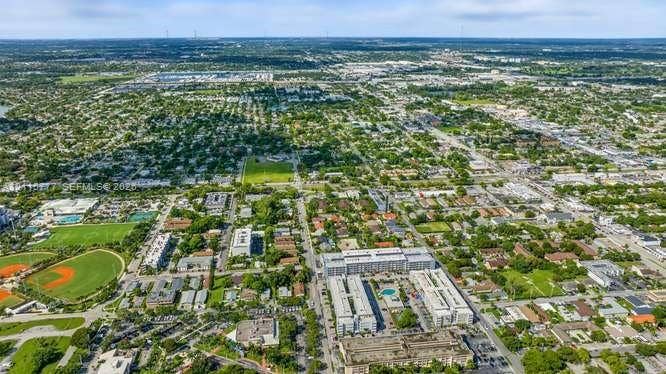 215 SE 3rd Avenue, #501B, Hallandale Beach, FL 33009 Aerial perspective of an established residential area featuring mature tree canopy, multi-family residential structures, green spaces, and recreational ball fields