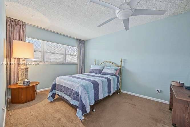 215 SE 3rd Avenue, #501B, Hallandale Beach, FL 33009 Room featuring wall-to-wall carpeting, a multi-pane window, and a ceiling fan