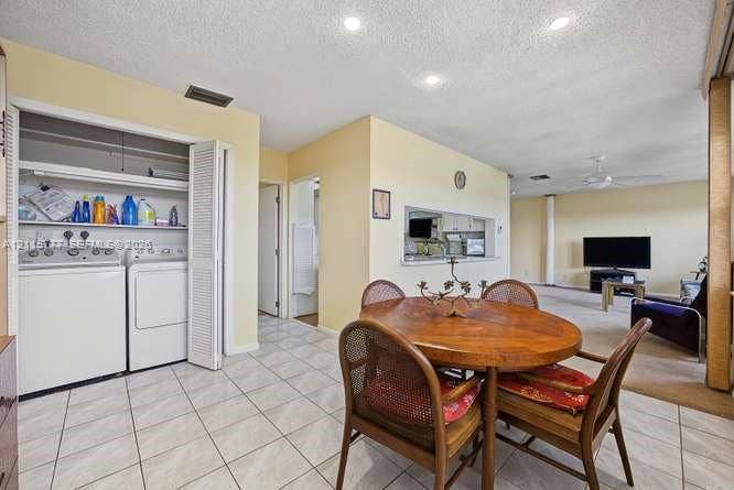 215 SE 3rd Avenue, #501B, Hallandale Beach, FL 33009 Dedicated laundry closet featuring louvered bi-fold doors and overhead shelving, paired with tile flooring and recessed lighting
