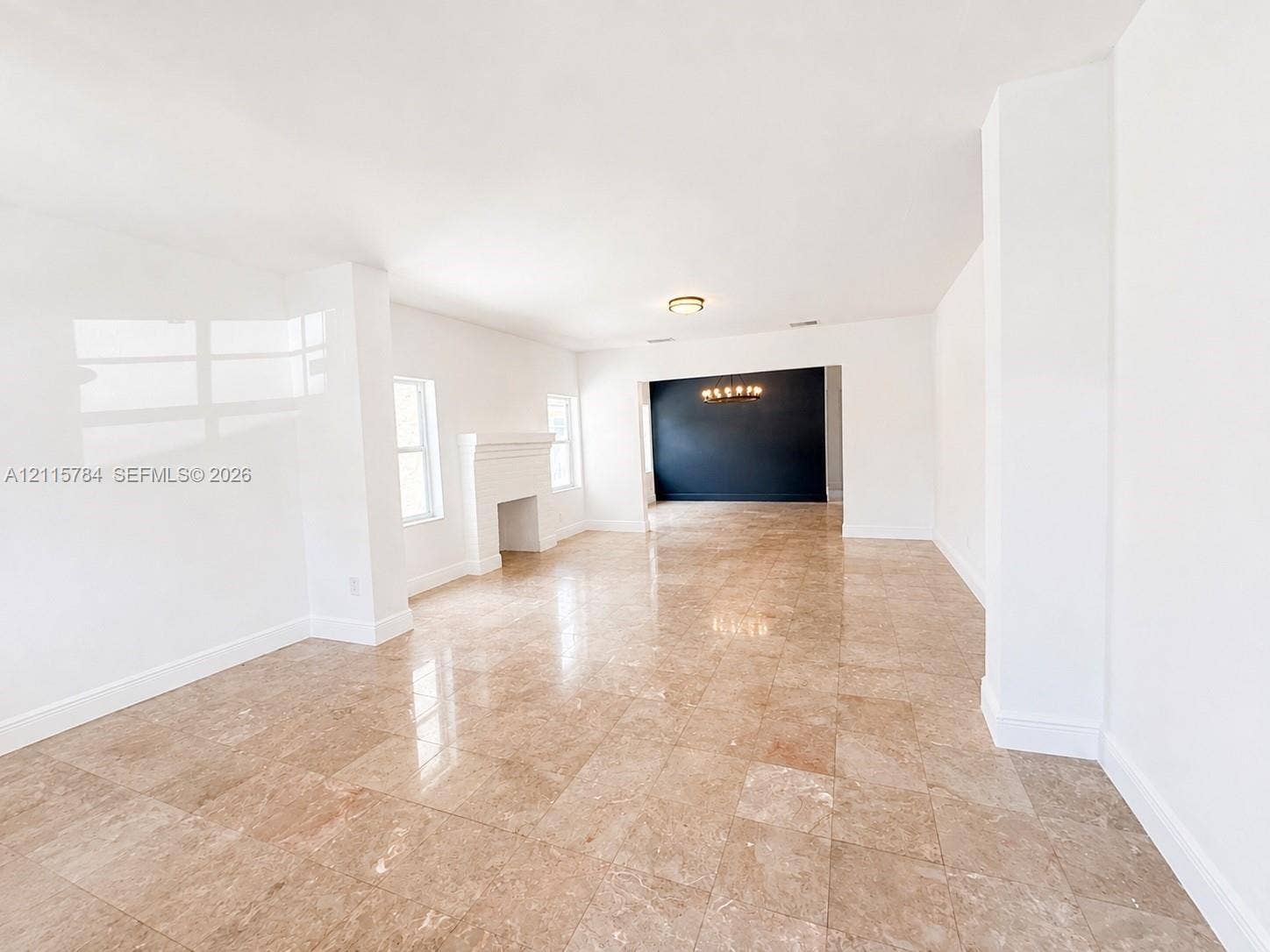 3655 SW 24th Terrace, #1, Miami, Miami, FL 33145 Polished stone flooring, fireplace with an architectural mantle, recessed lighting, and a contrasting feature wall