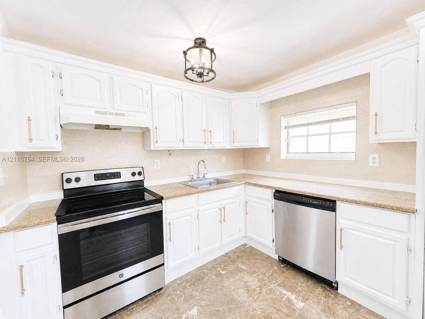 3655 SW 24th Terrace, #1, Miami, Miami, FL 33145 Kitchen featuring white shaker-style cabinetry with gold-tone hardware, stone-finish countertops, stainless steel appliances, stone-tile flooring, and a decorative lantern-style pendant light fixture