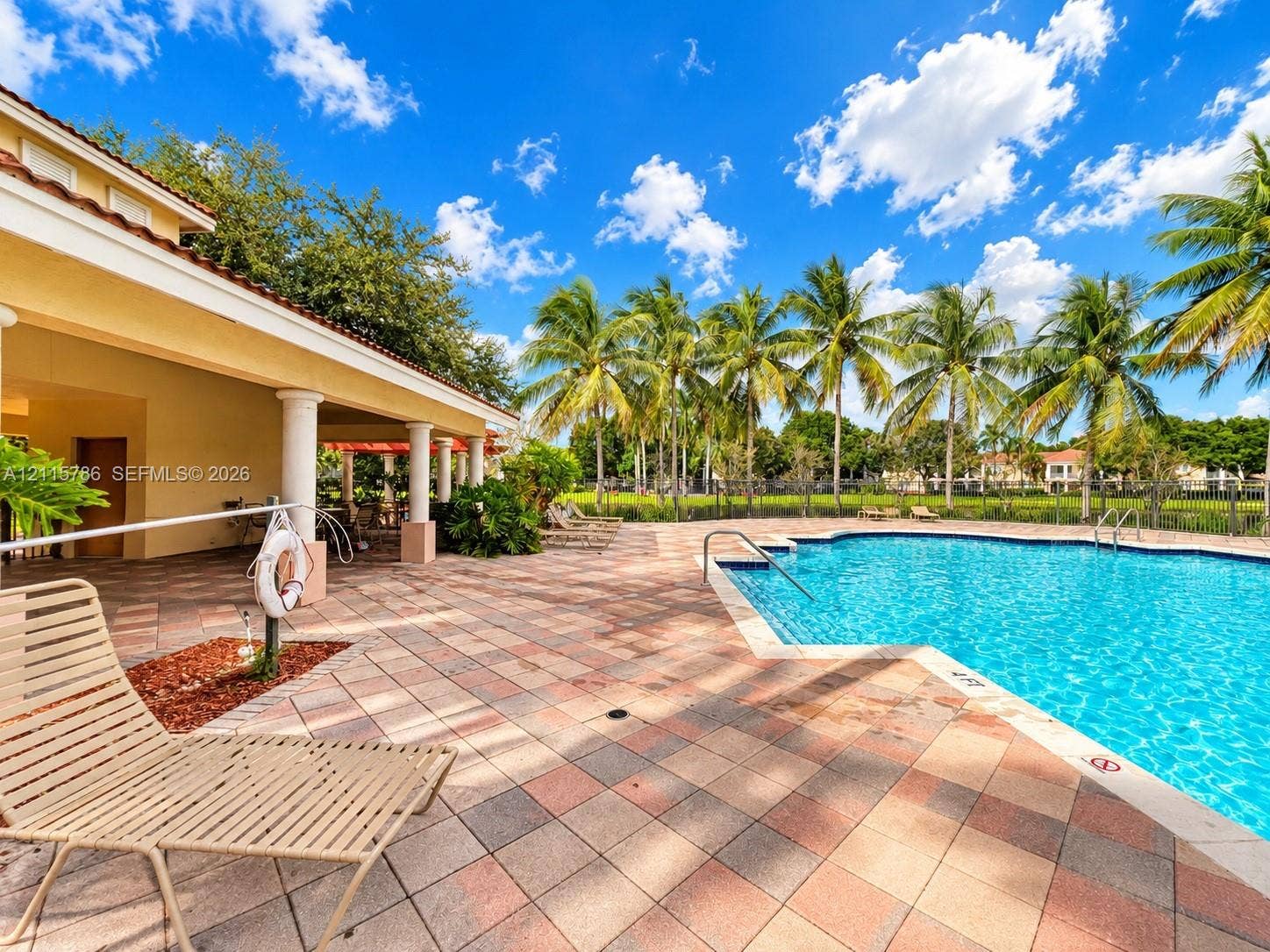 2494 Centergate Drive, #202, Miramar, Miramar, FL 33025 Swimming pool with a tile deck and covered patio featuring structural columns