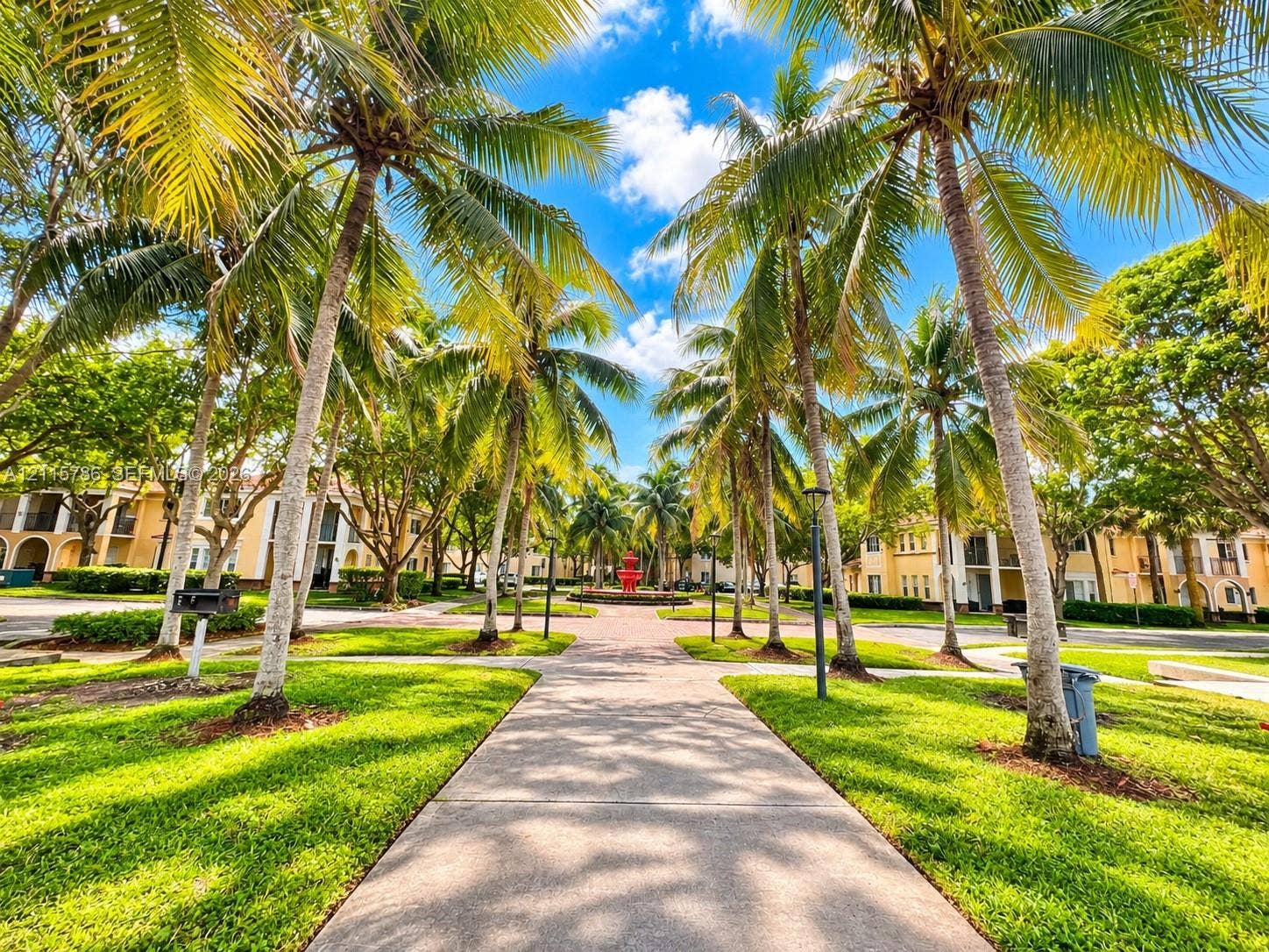 2494 Centergate Drive, #202, Miramar, Miramar, FL 33025 Paved walkway lined with mature palm trees, manicured lawns, and a central fountain